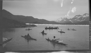 Image: 8 kayakers, women in oomiak [umiak] 